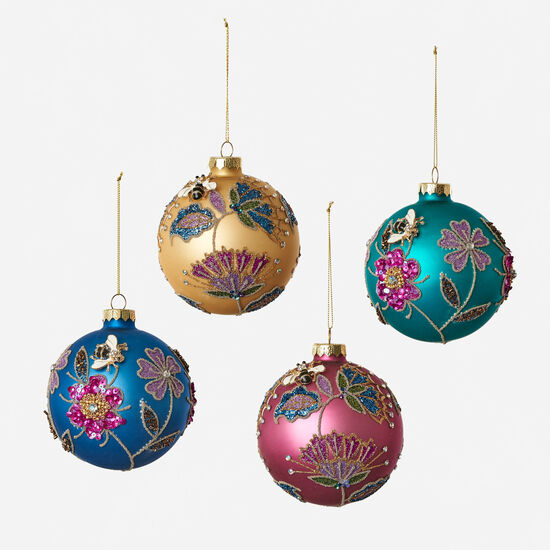 Glass ball ornament featuring a sequin floral pattern with a four-inch diameter.