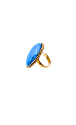 Oversized turquoise cabochon ring in a textured antique-style gold setting with a wide band.