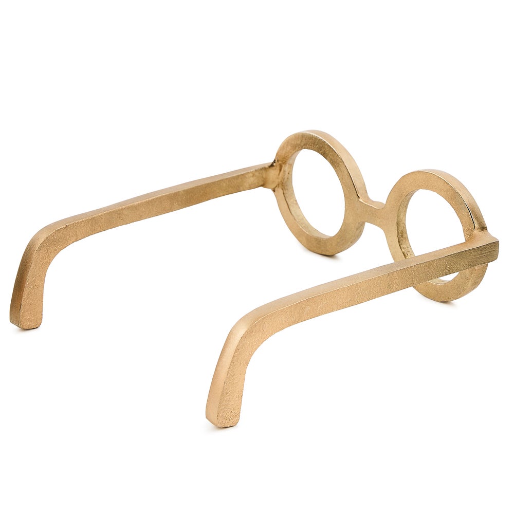 A decorative aluminum sculpture shaped like round eye glasses in a gold finish.