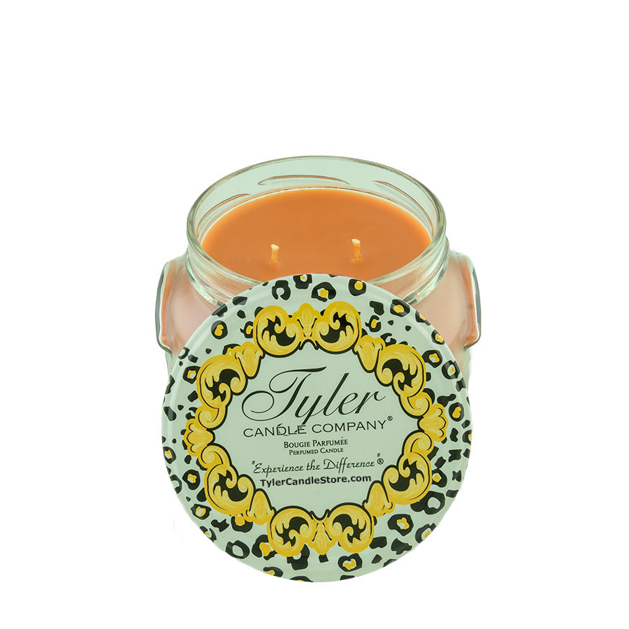 11oz Tyler Candle in a glass jar with two wicks and a decorative leopard print lid.