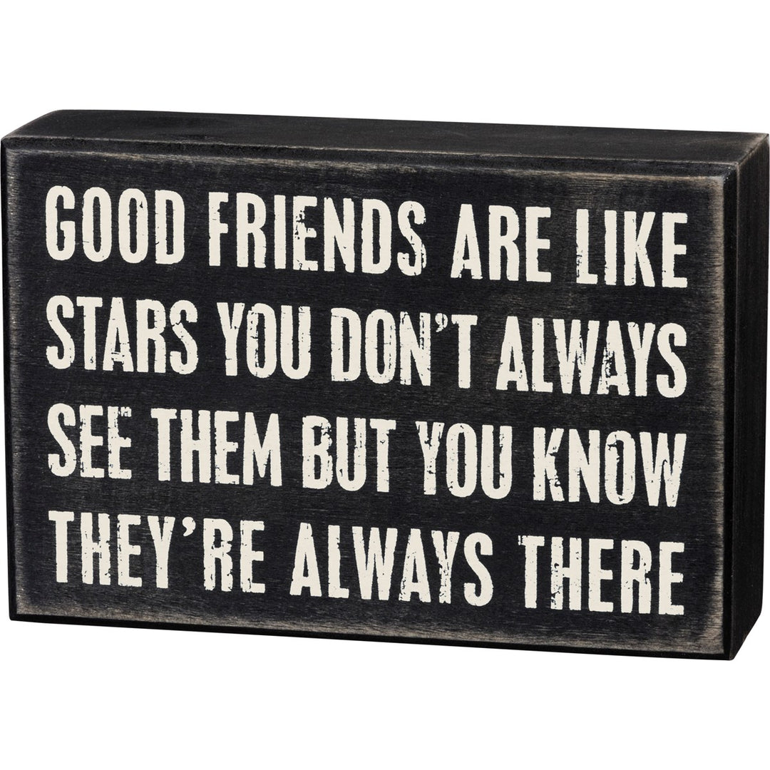 Black wooden box sign with white text reading 'Good friends are like stars you don't always see them but you know they're always there.'