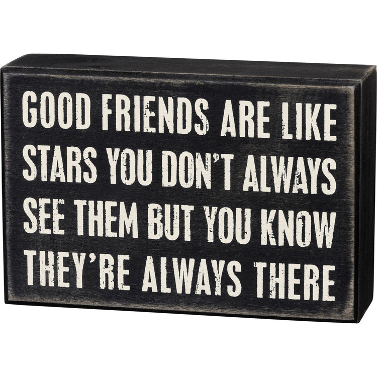 Black wooden box sign with white text reading 'Good friends are like stars you don't always see them but you know they're always there.'
