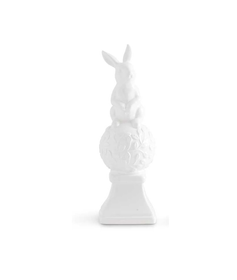White ceramic finial shaped like two bunnies sitting on top.