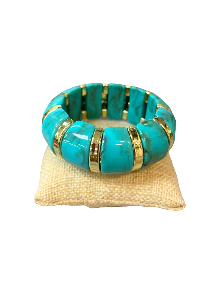 Turquoise marbled stretch bracelet with chunky rectangular beads and gold-tone spacer rings.