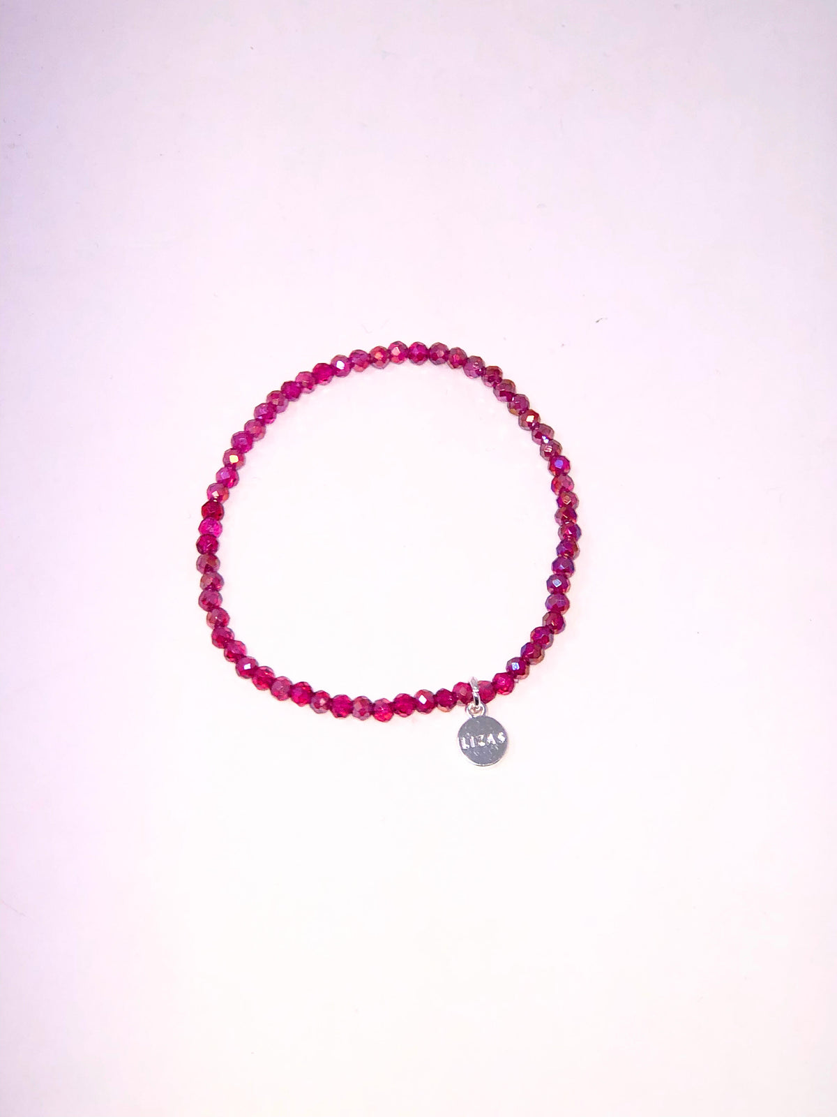 Stretchy beaded bracelet with faceted glass beads in a colorful pattern.