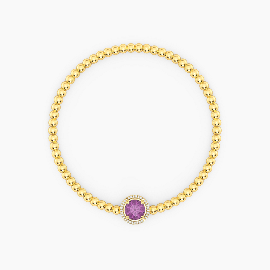 Gold-plated beaded bracelet with a round purple birthstone charm and diamond halo.