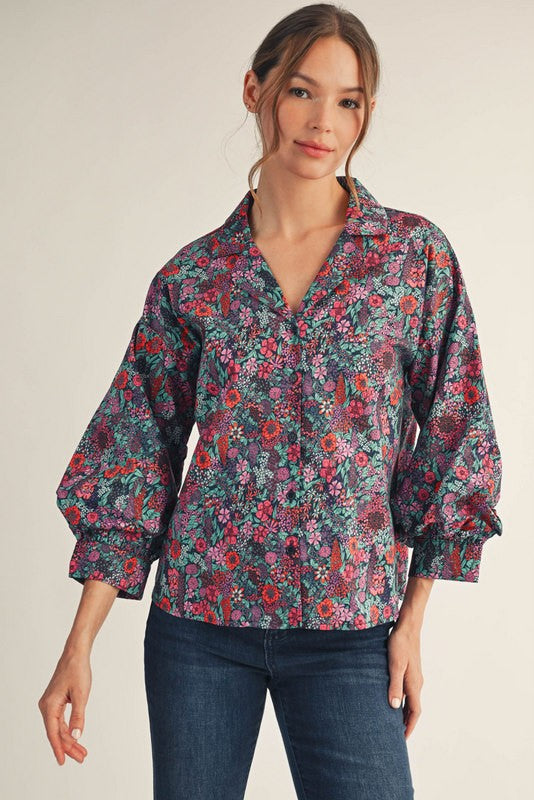 Woman wearing a small Riley button-down floral top with three-quarter sleeves, collar, and cotton fabric.
