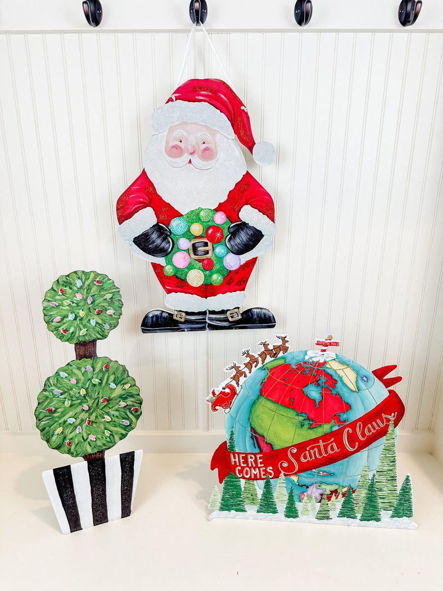 Red PVC Santa door hanger with white beard and hat hanging on a hook.