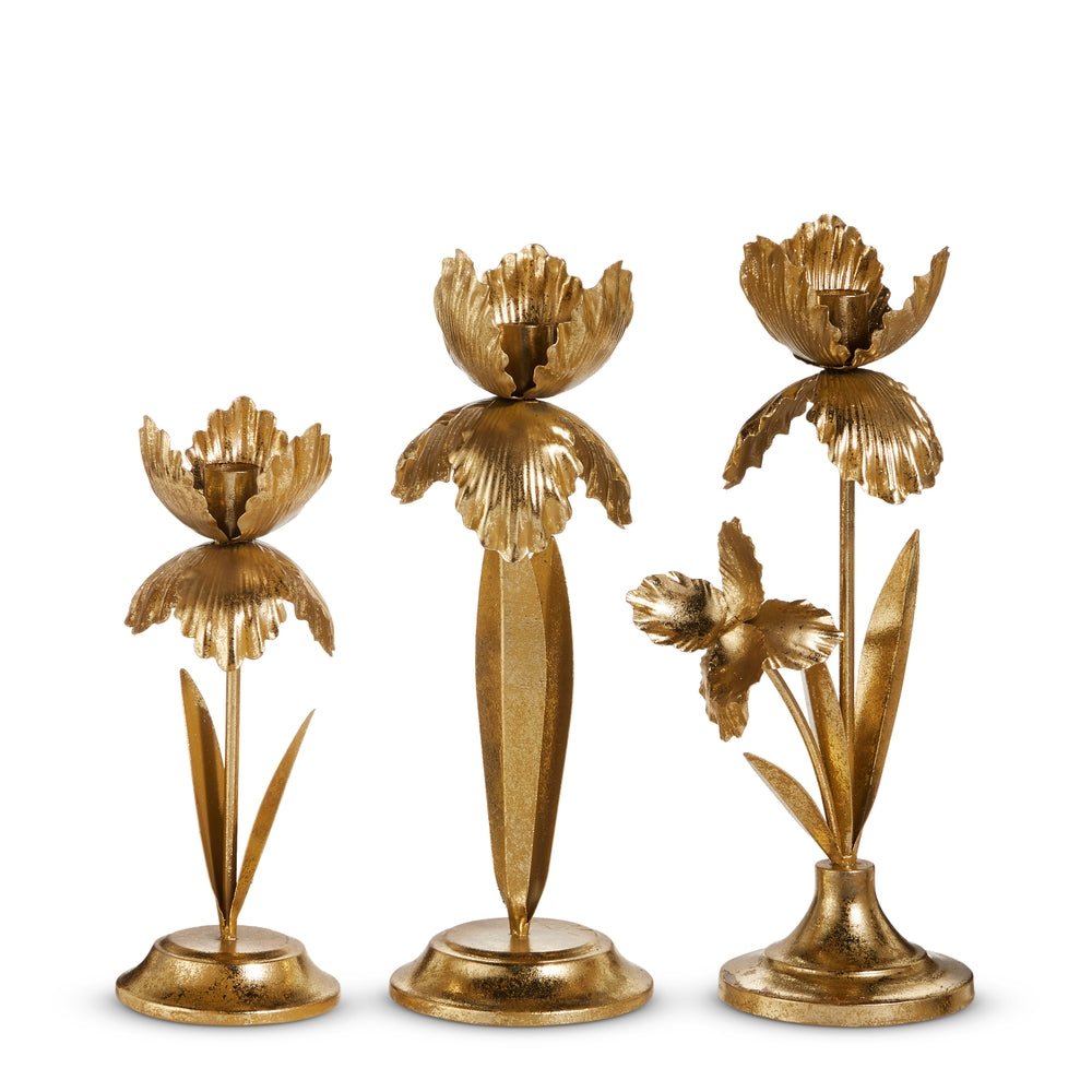 Gold iron candle holder with floral cutout patterns on a vertical stand.