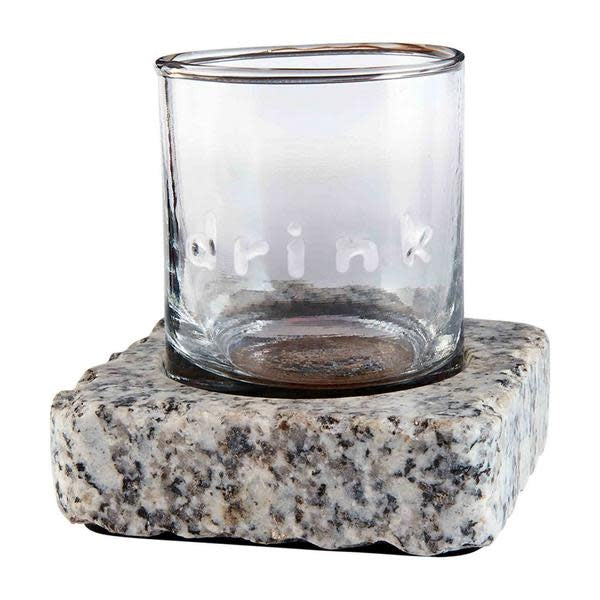 Gray granite chilling stone next to an embossed double old fashioned glass