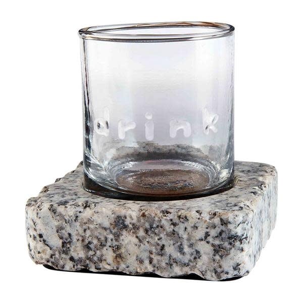 Gray granite chilling stone next to an embossed double old fashioned glass