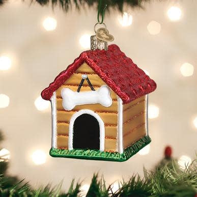 Small wooden dog house ornament with a peaked roof in natural wood finish.