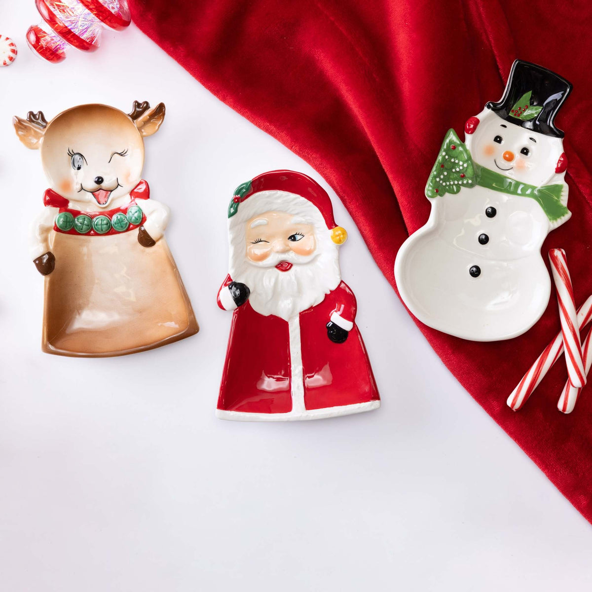 Square dolomite platter with vintage Christmas character illustrations in red, green, and white.