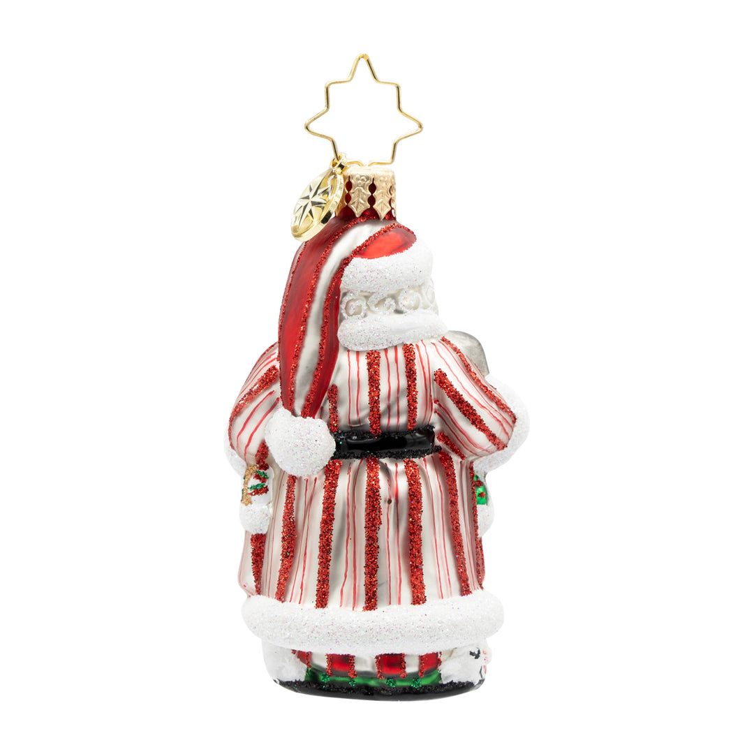 Back view of a glass Santa ornament wearing a red and white glitter-striped robe and hat.
