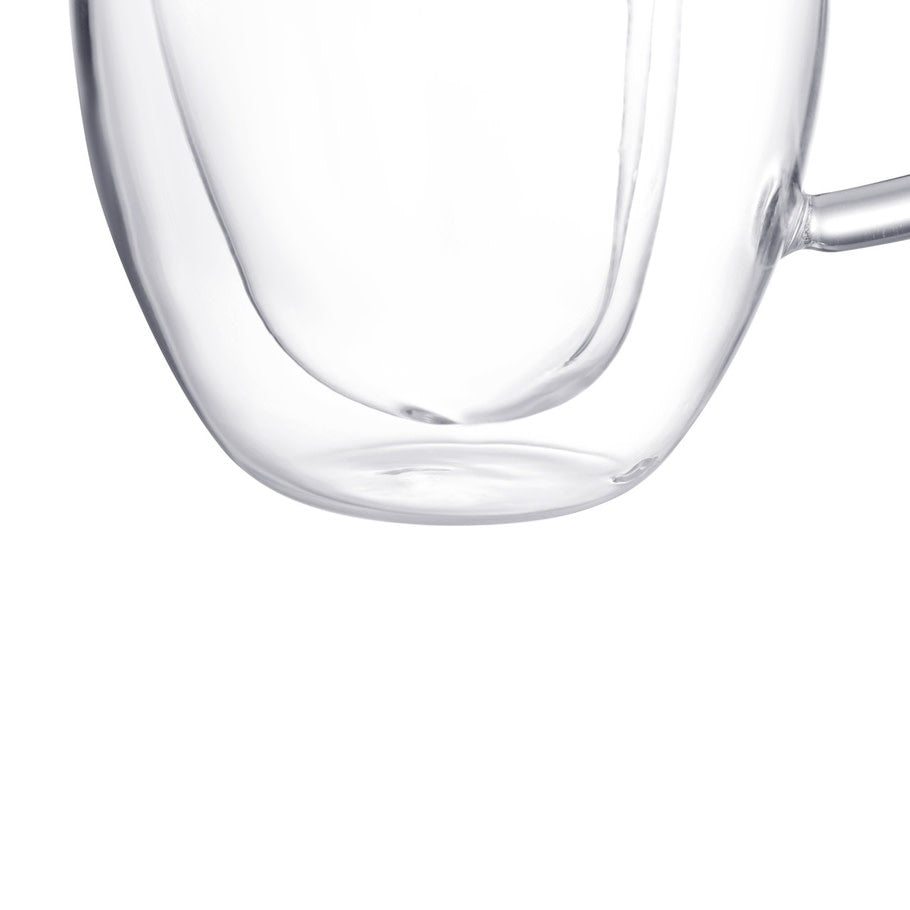 Double-walled clear heart-shaped espresso cup with visible interior brew