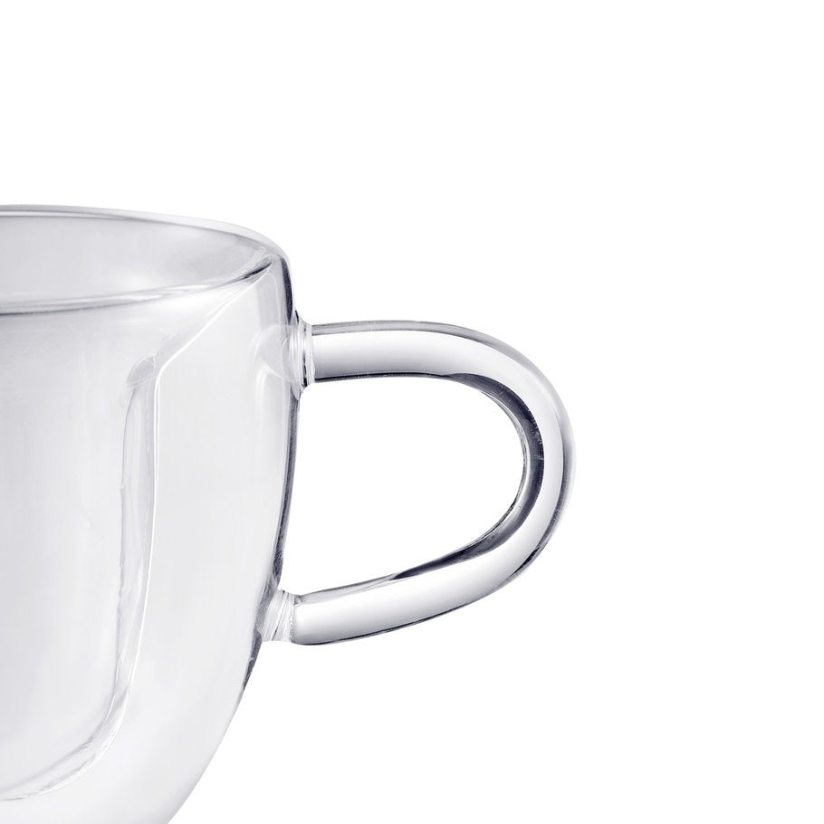 Clear heart-shaped double-walled espresso cup holding coffee