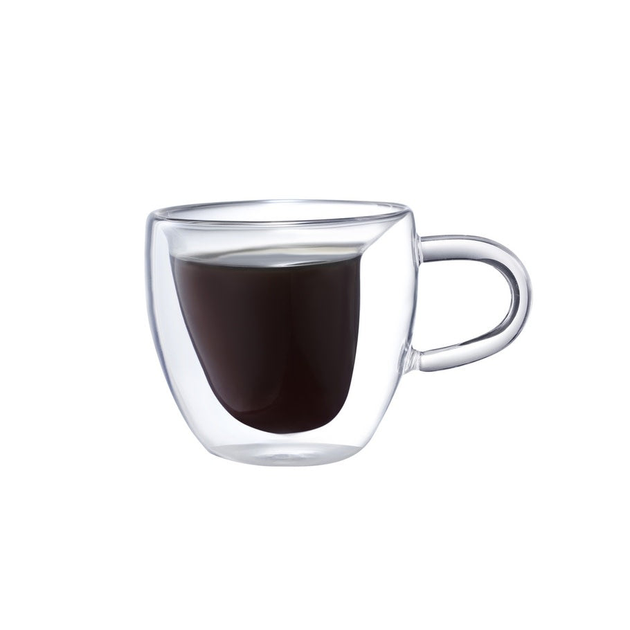 Double-walled clear heart-shaped espresso cup holding coffee