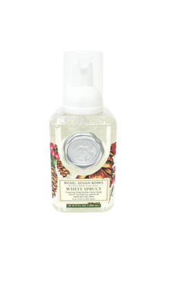 White Spruce mini foaming hand soap by Michel Design Works with a silver seal and pinecone design.