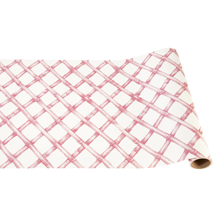 Pink lattice runner rug with geometric cutout patterns on a soft background.
