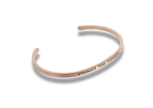 Rose gold cuff bracelet engraved with the words STRONGER THAN YESTERDAY.