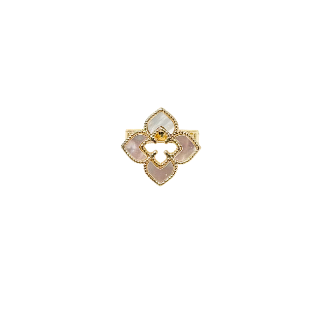 Gold fashion statement ring with a four-petal floral design and mother of pearl inlays.