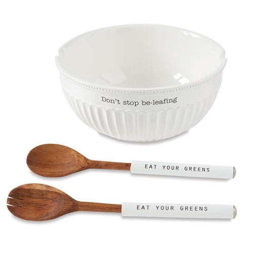 Set of two beige ceramic salad bowls with matching wooden utensils.