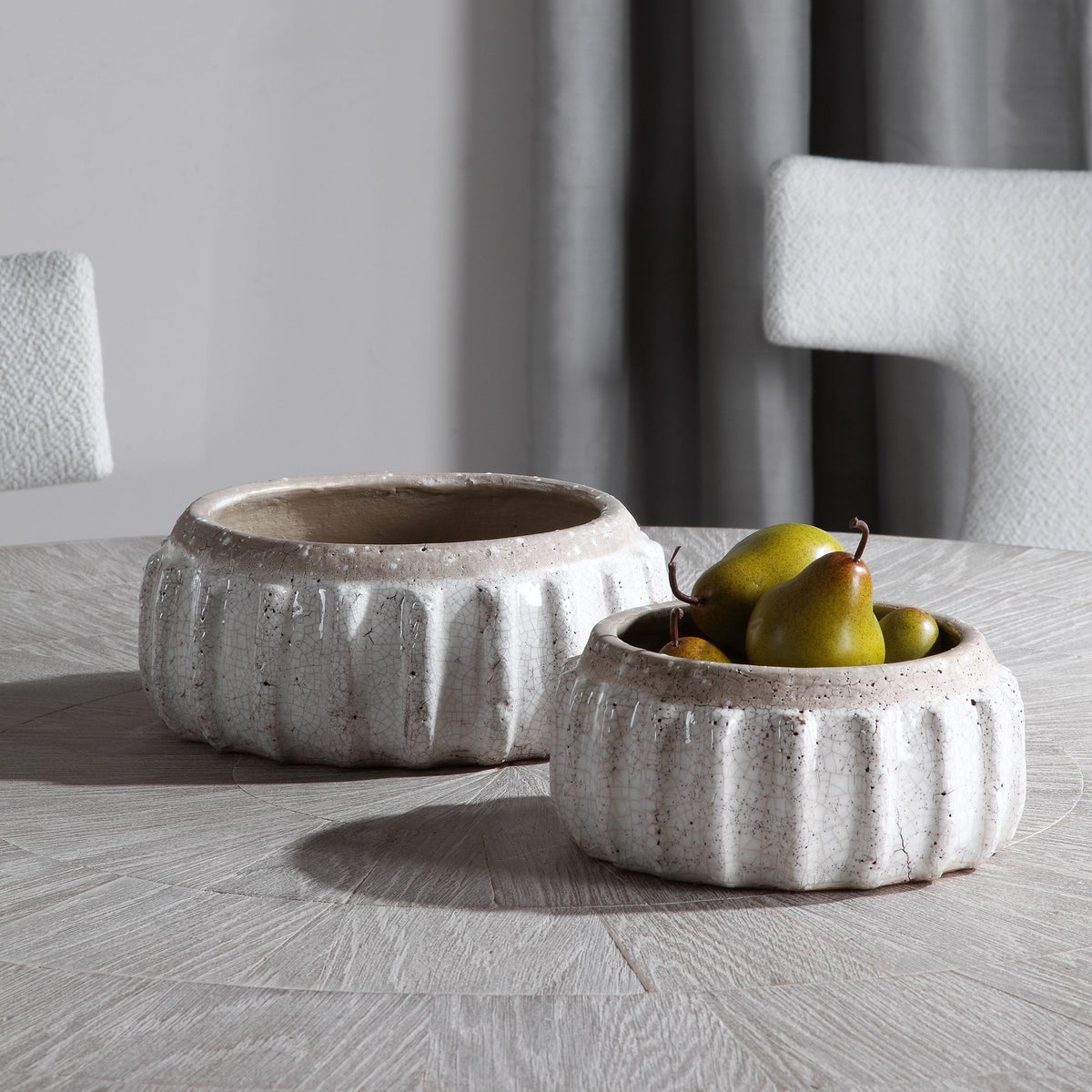 Set of two distressed ceramic bowls with a natural earthy finish.
