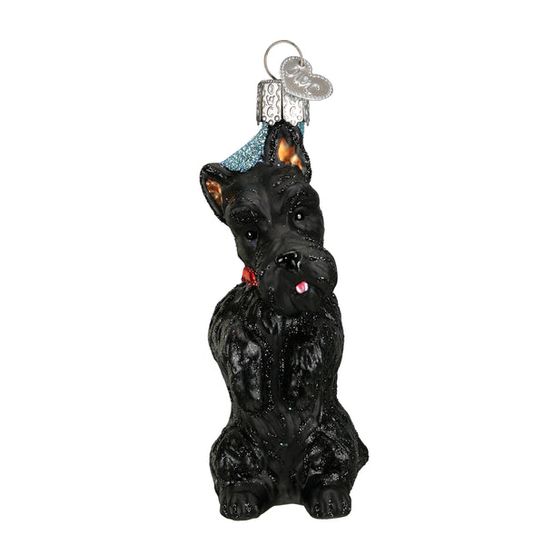 Black glass Scottish Terrier Christmas ornament with a red collar and blue glitter hat.