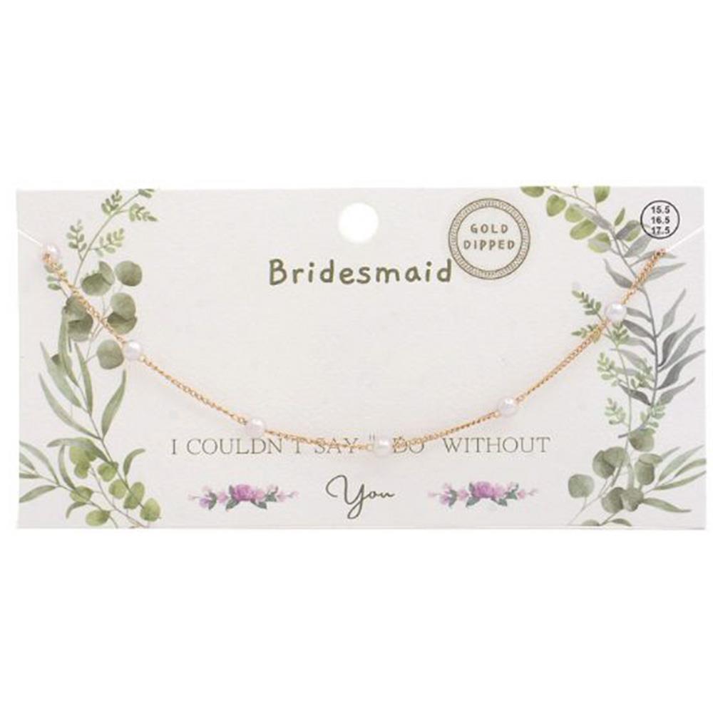 Gold-dipped pearl station necklace on a 'Bridesmaid' gift card with floral accents.