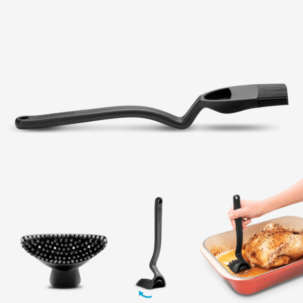 Black silicone basting brush with weighted handle and flexible head featuring four internal holes.