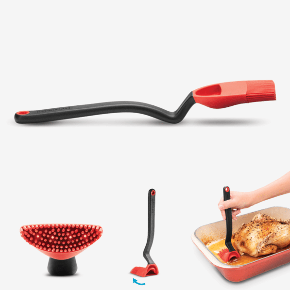 Red silicone basting brush with weighted handle and four internal holes for controlled liquid release.