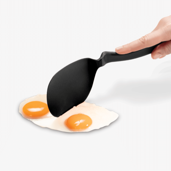 Black nylon Chopula spatula with thin flexible head designed for flipping and chopping.