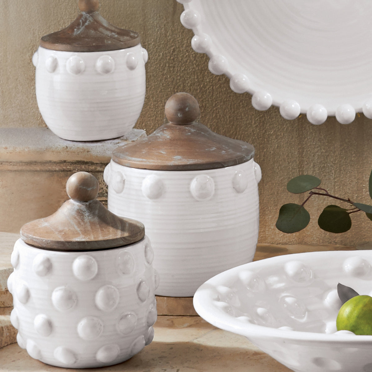 Raised Dot Canister in natural wood finish with a textured dot pattern on the lid and cylindrical silhouette.