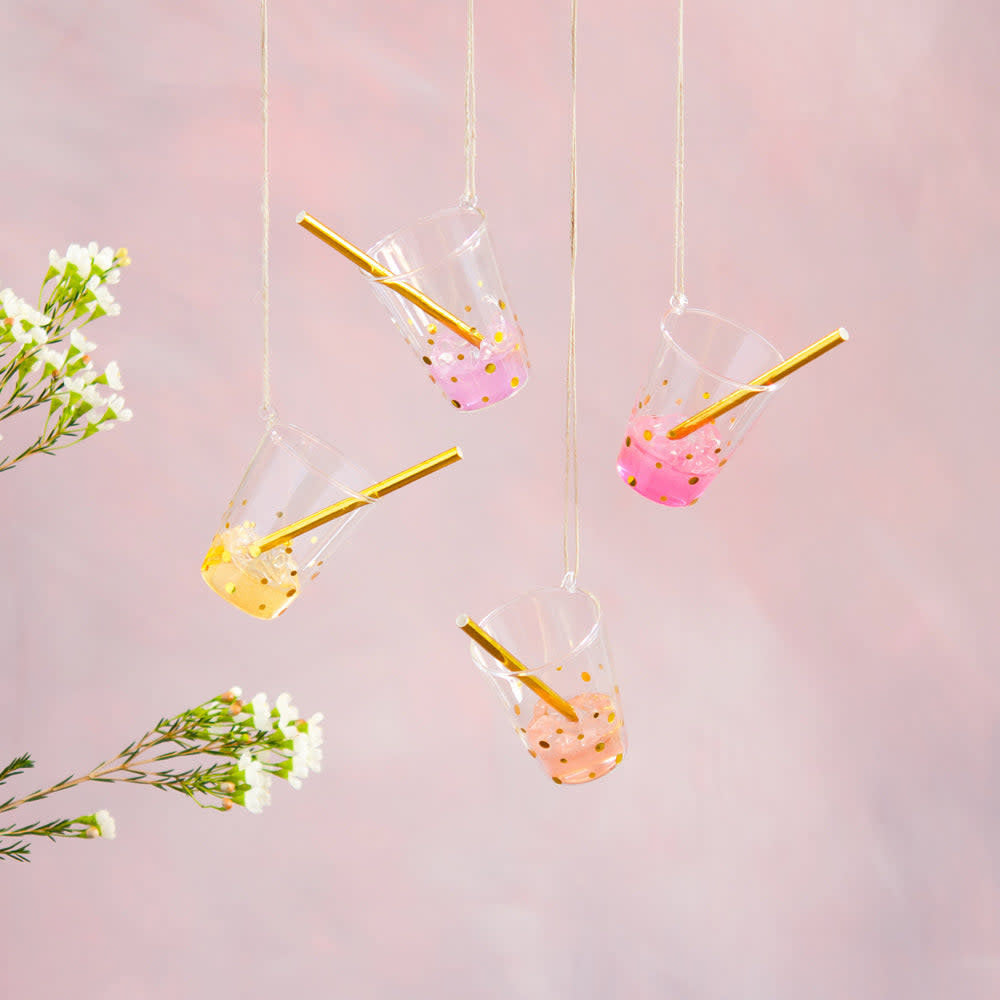 Hand-blown glass drink ornament with straw in red featuring gold glitter accents.