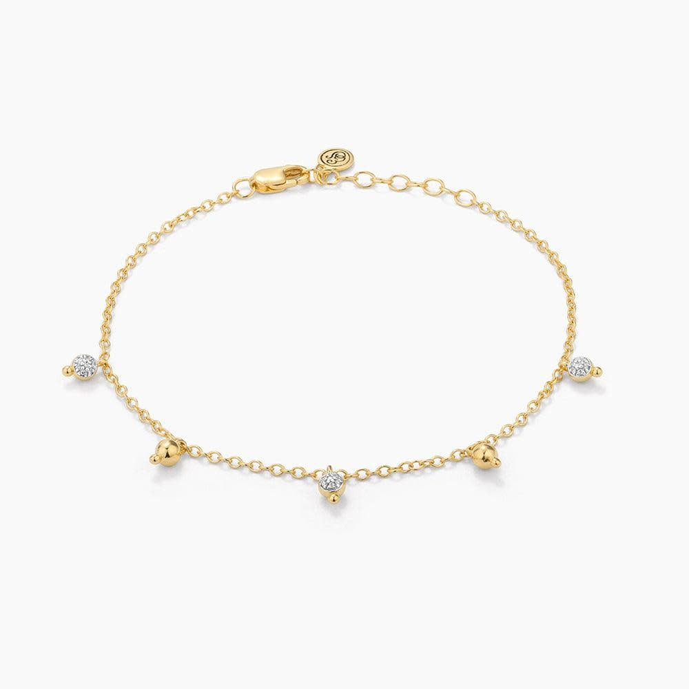 Silver chain bracelet with a shimmering teardrop diamond pendant featuring lobster clasp closure.