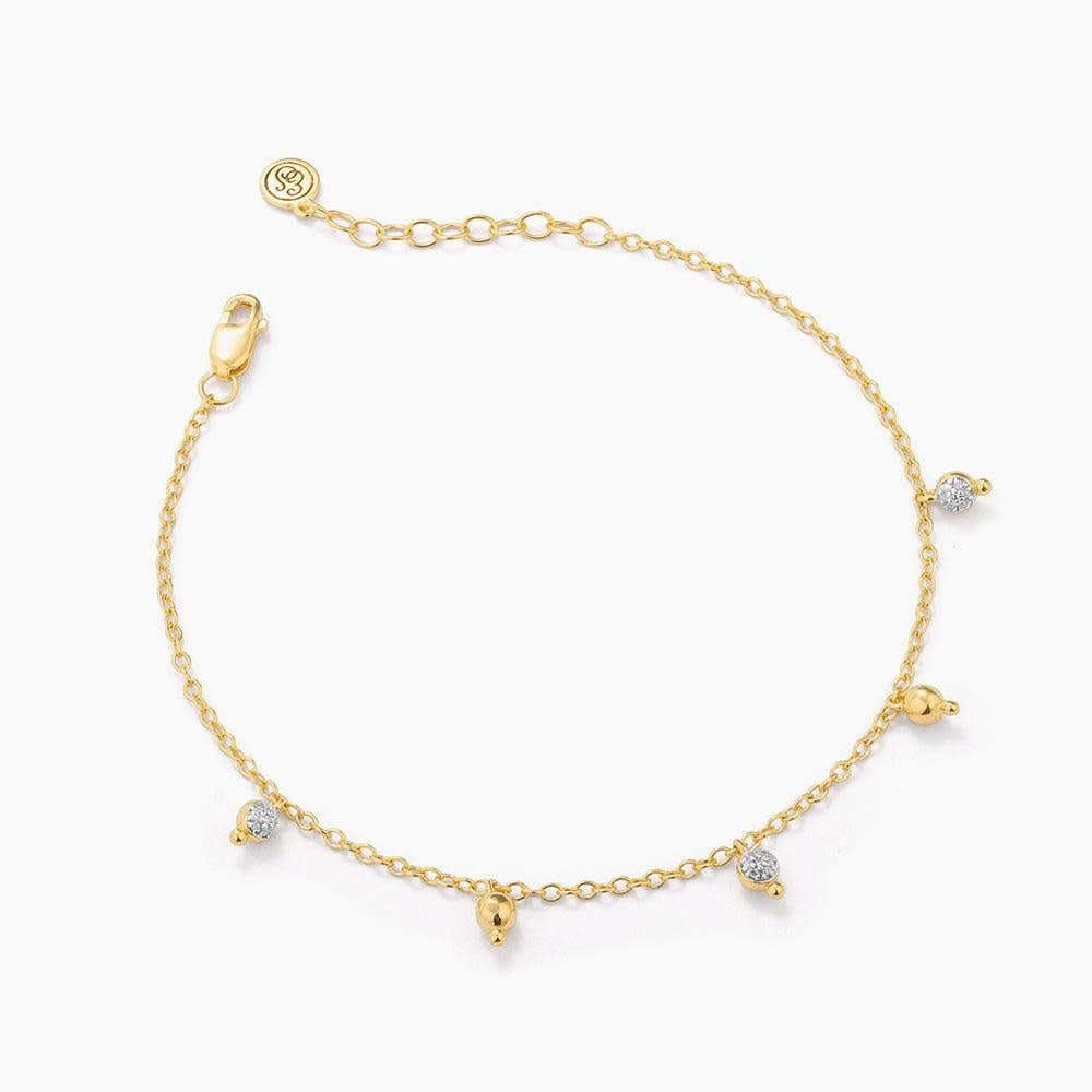 Silver chain bracelet with a shimmering teardrop diamond pendant on lobster clasp closure.