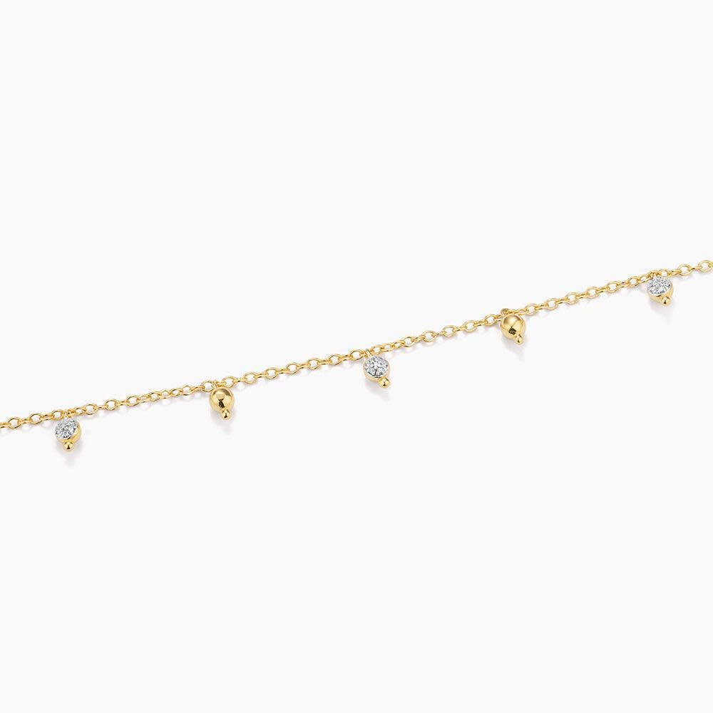 Silver chain bracelet with a shimmering teardrop diamond pendant featuring a lobster clasp closure.