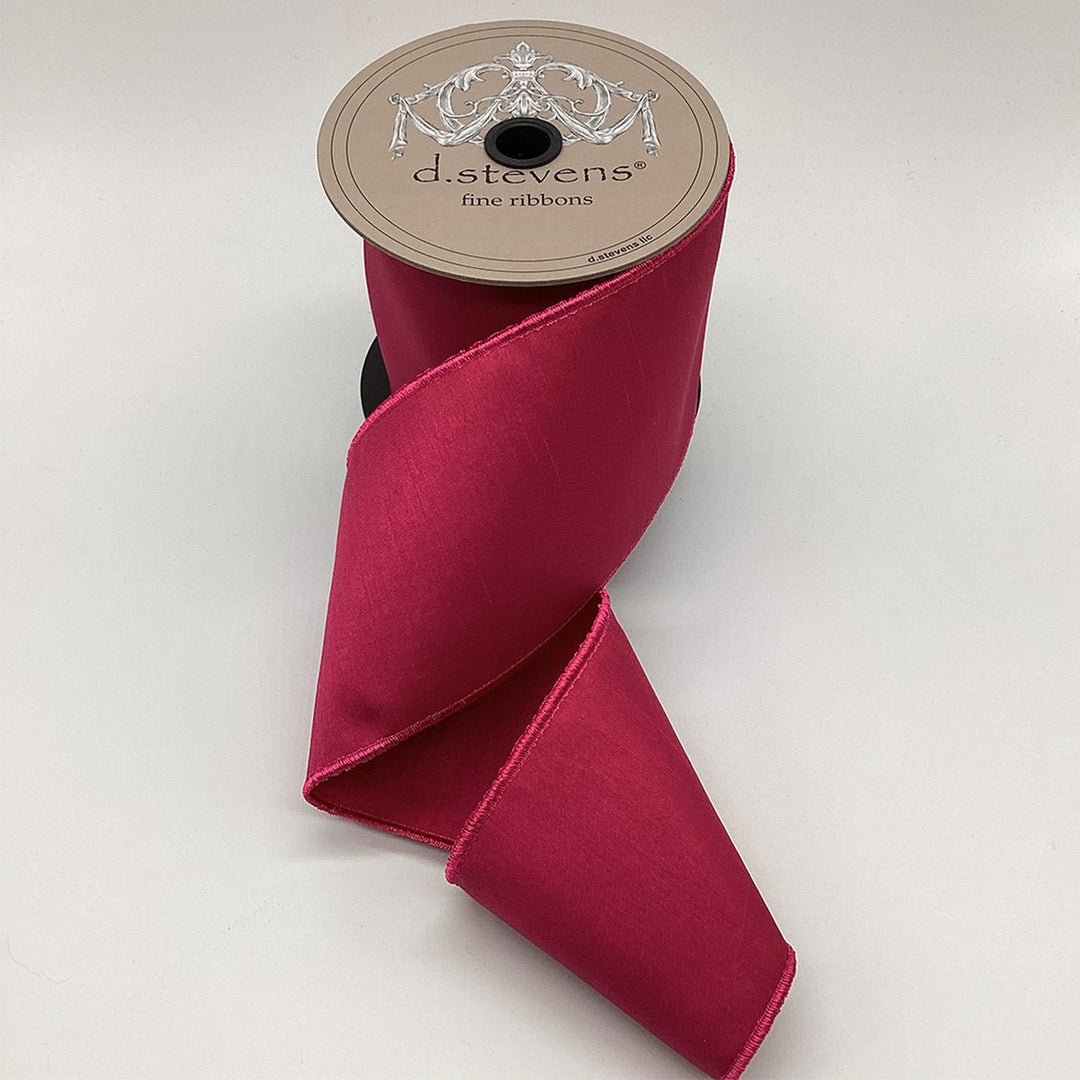 4 inch wide magenta Faux Dream Dupion ribbon on a spool with a textured, elegant sheen.