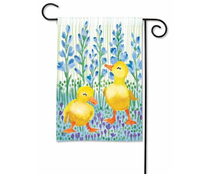 Garden flag with two yellow ducklings in a field of blue lupine flowers.