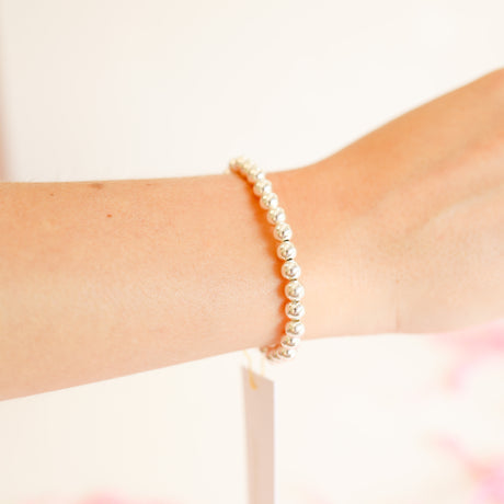 Silver beaded bracelet featuring a delicate chain with small metallic beads.