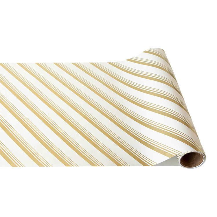 Gold and white peppermint stripe paper table runner unrolled from a spool.