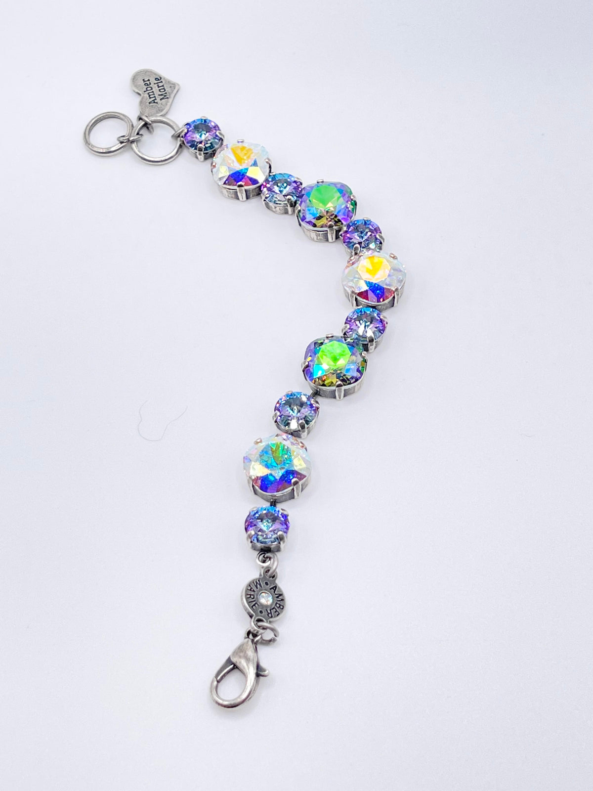 Silver-tone bracelet featuring alternating large and small iridescent crystal stones.