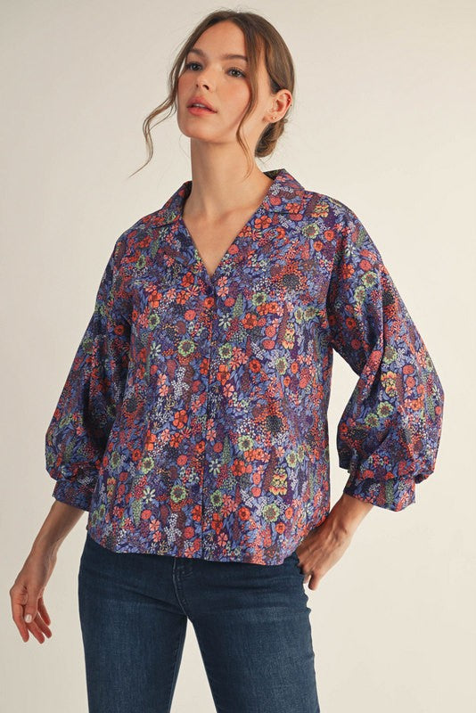 Woman wearing a small Riley button-down floral top with three-quarter sleeves, collared neckline, and cotton fabric.