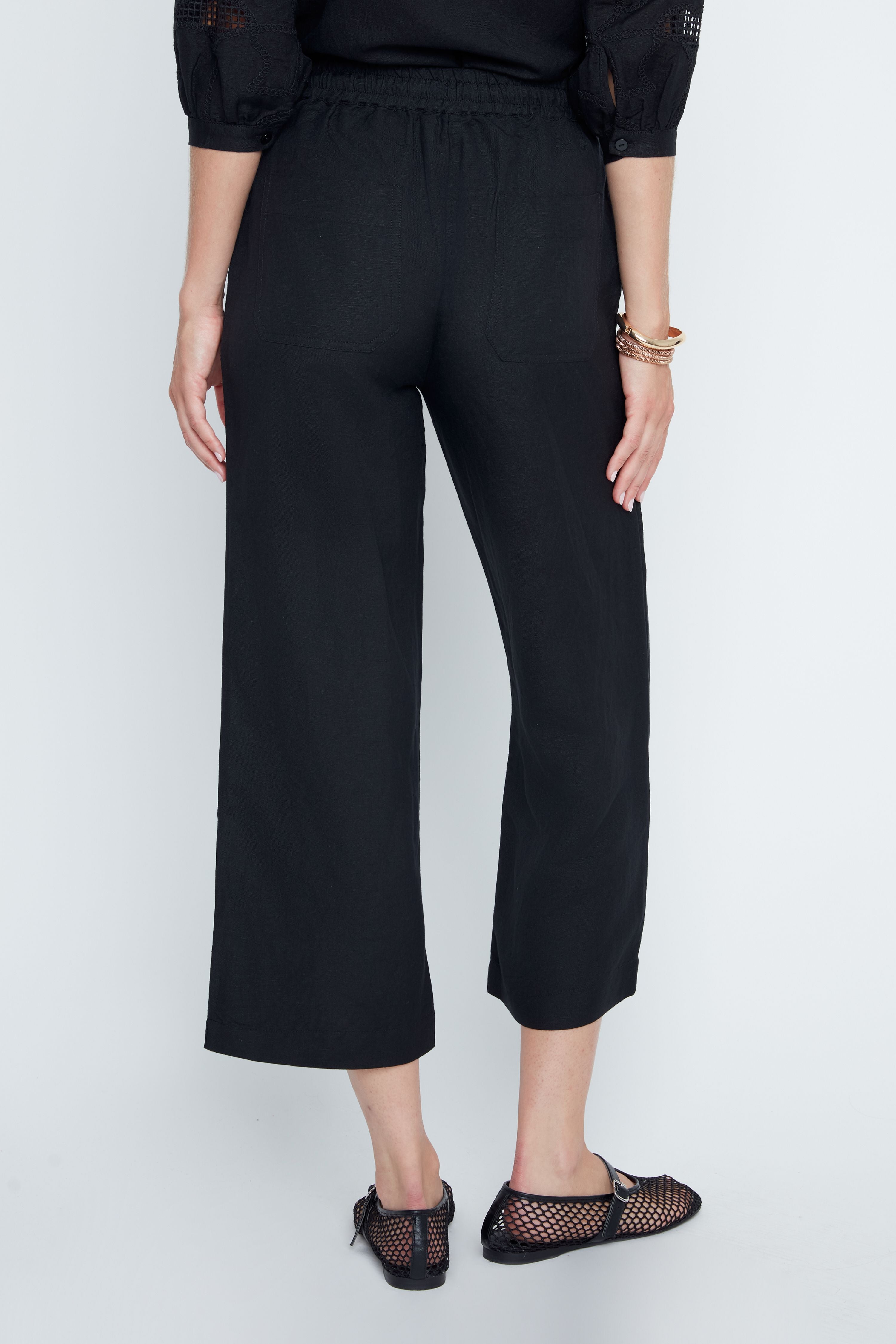 Women's Victoria woven pants in neutral tone with elastic waistband, drawstring, side pockets, and cropped relaxed silhouette.