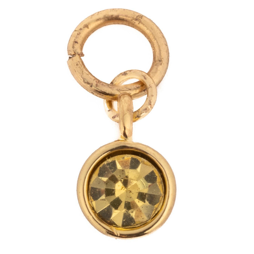 Thea Charm Birthstone featuring a round yellow gemstone in a gold-toned bezel setting with rings.