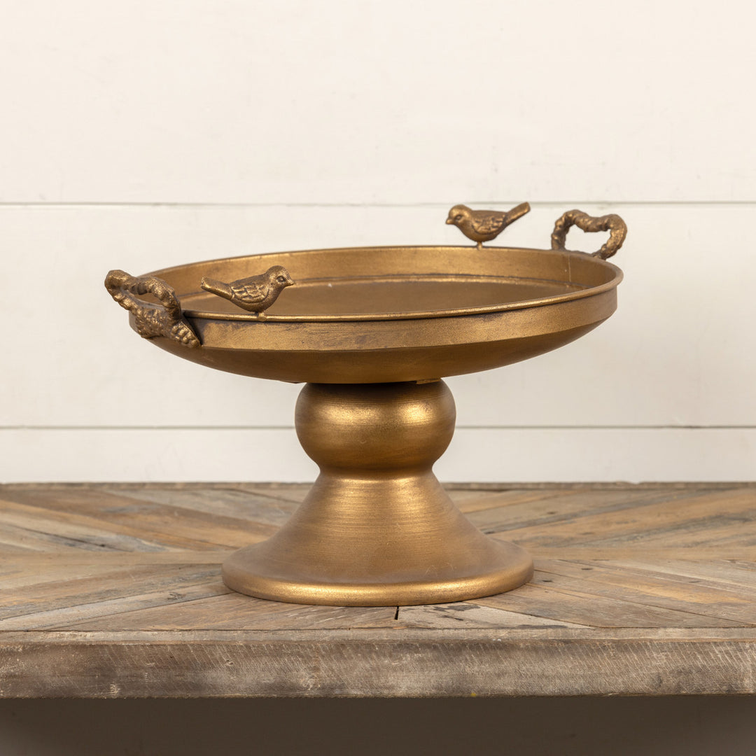 Raised gold metal tray with bird silhouettes on a square surface