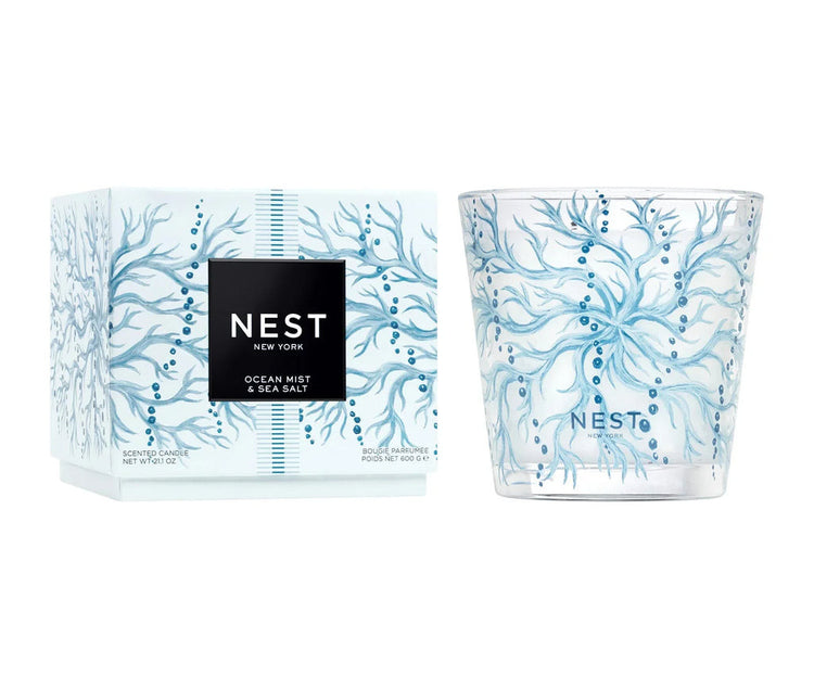 Nest Ocean Mist & Sea Salt 3-wick candle in a blue coral-patterned glass jar next to its box.