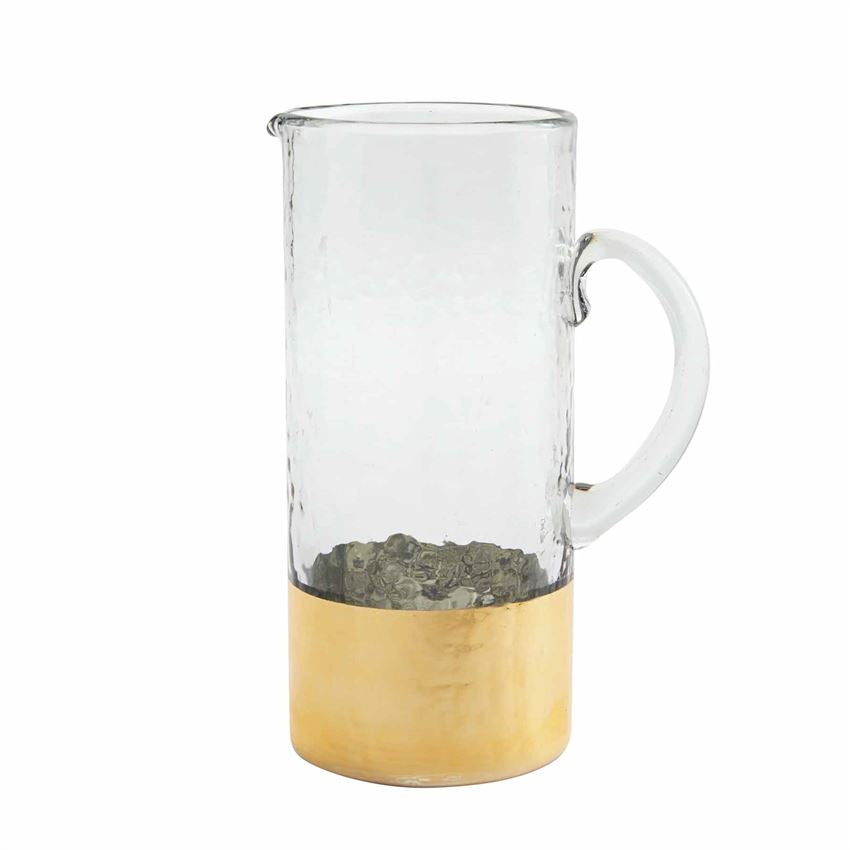 Gold hammered glass pitcher with a clear liquid interior