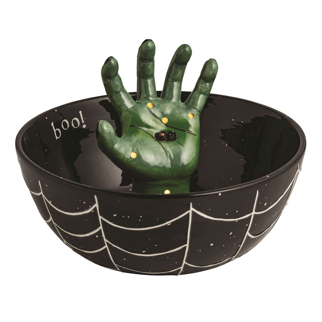 Black ceramic treat bowl with white spiderweb design and a green light-up hand rising from the center