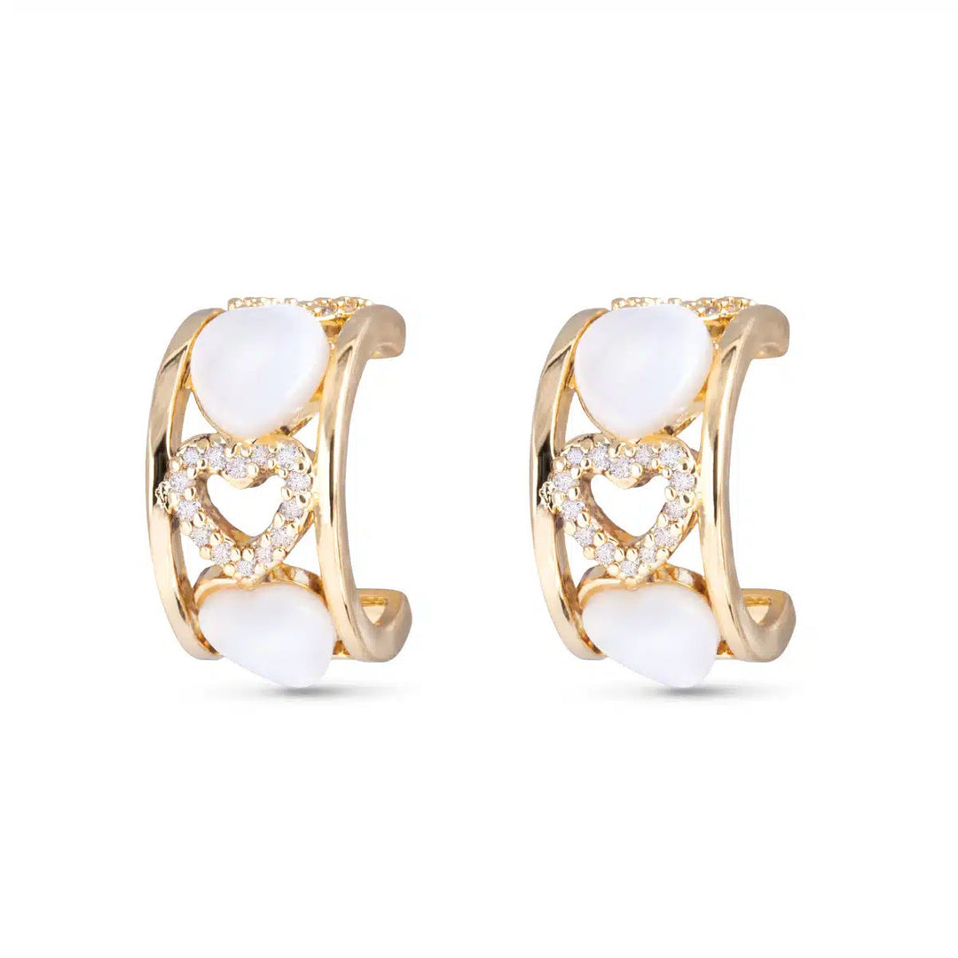Gold huggie hoop earrings featuring CZ-encrusted and mother-of-pearl heart charms.